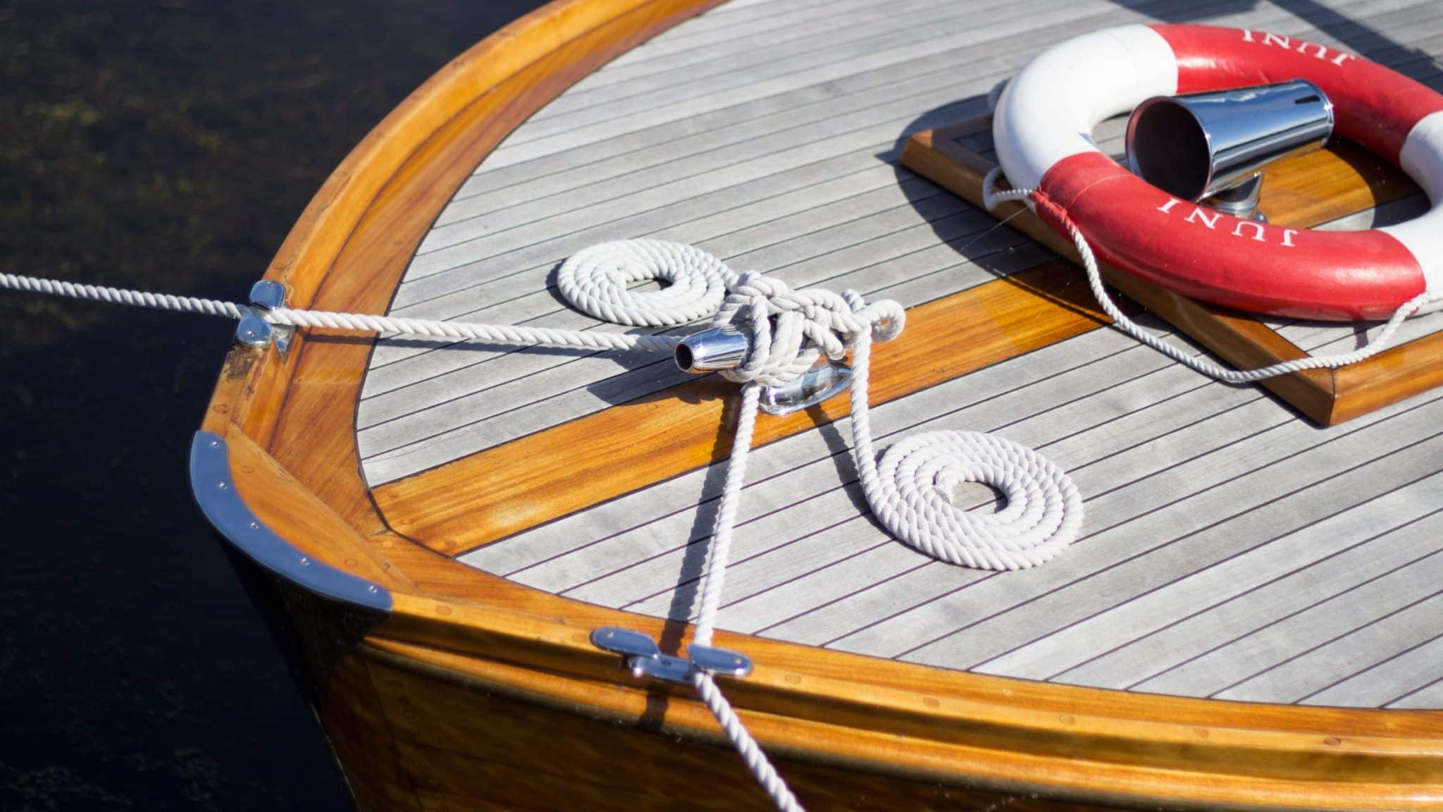 Wooden boat deck with rope and lifebuoy